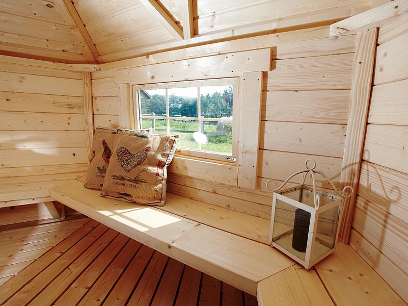 Wolff Finnhaus Grillkota Basic 9 mit Grillanlage schwarze Schindeln und rundem Tisch